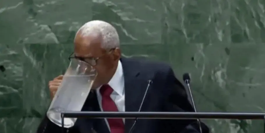 Haitian Politician drinking big water during UN speech meme template
